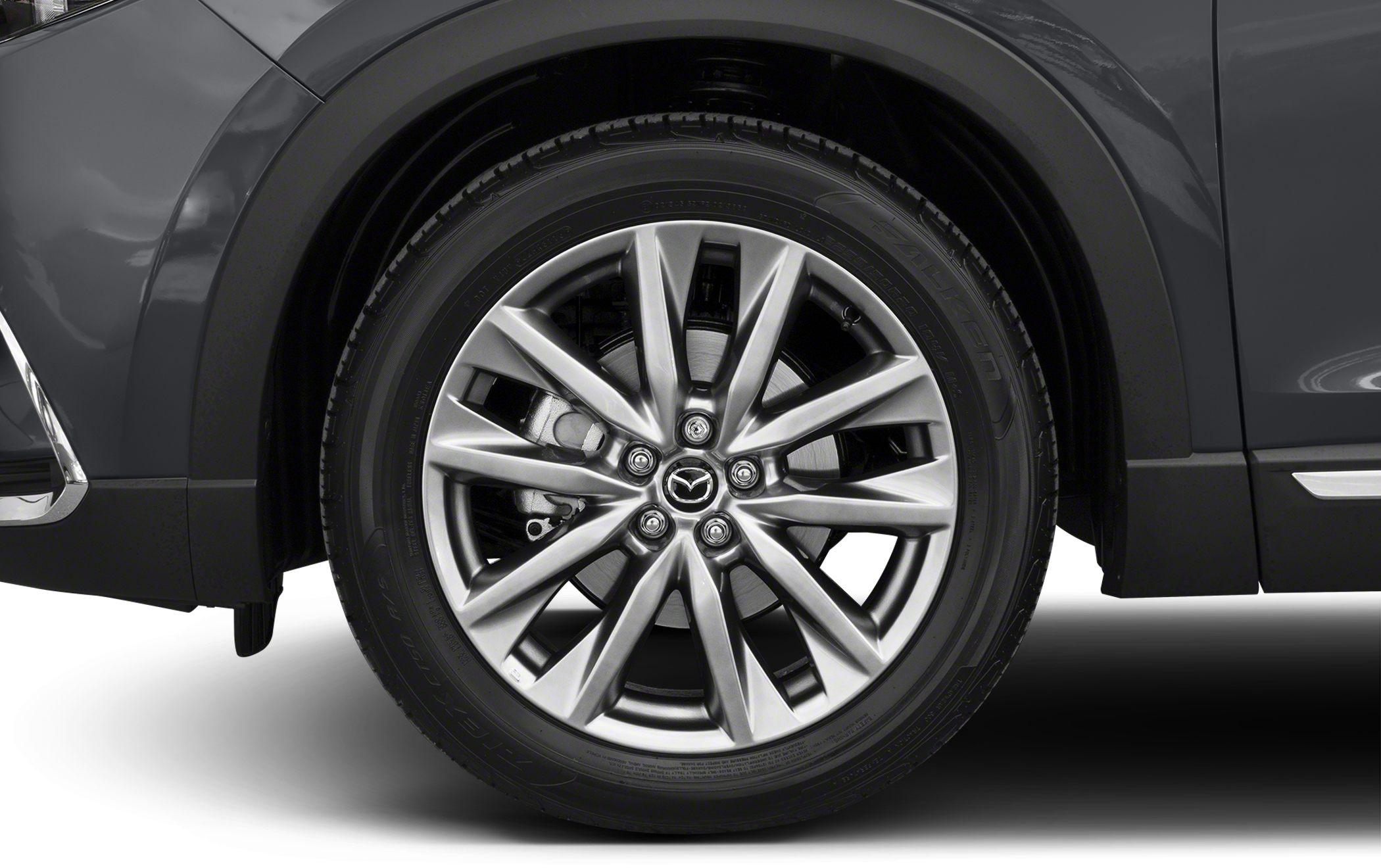 Close-up of alloy wheel with Mazda logo and multi-spoke rim design