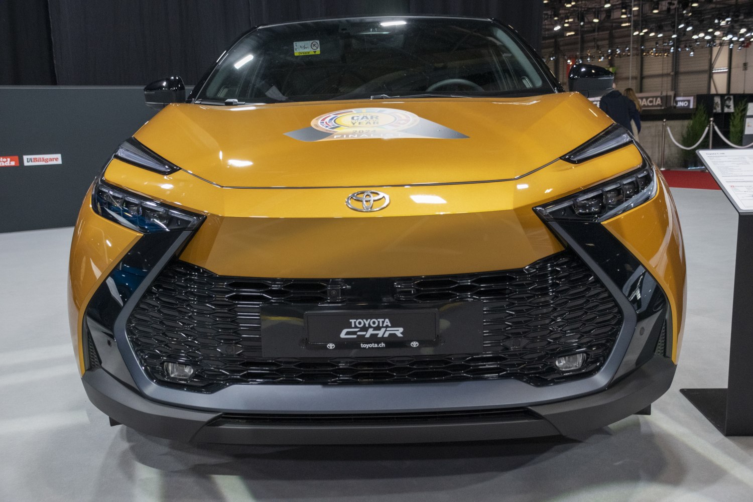 Angular headlights and large black mesh grille at front.