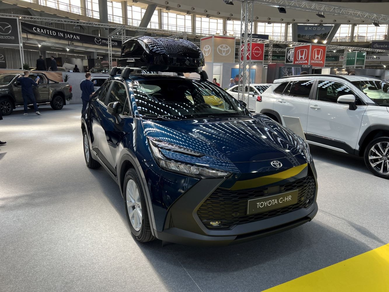 Blue compact crossover with LED headlights and roof cargo box