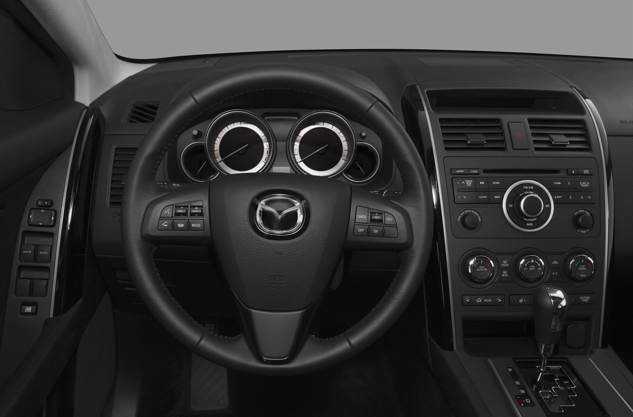 Steering wheel with control buttons and dashboard instrument cluster