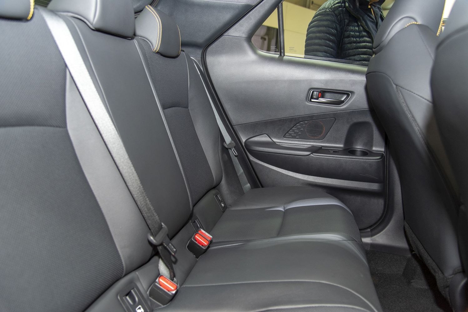 Black rear seat interior with seat belts and door panel