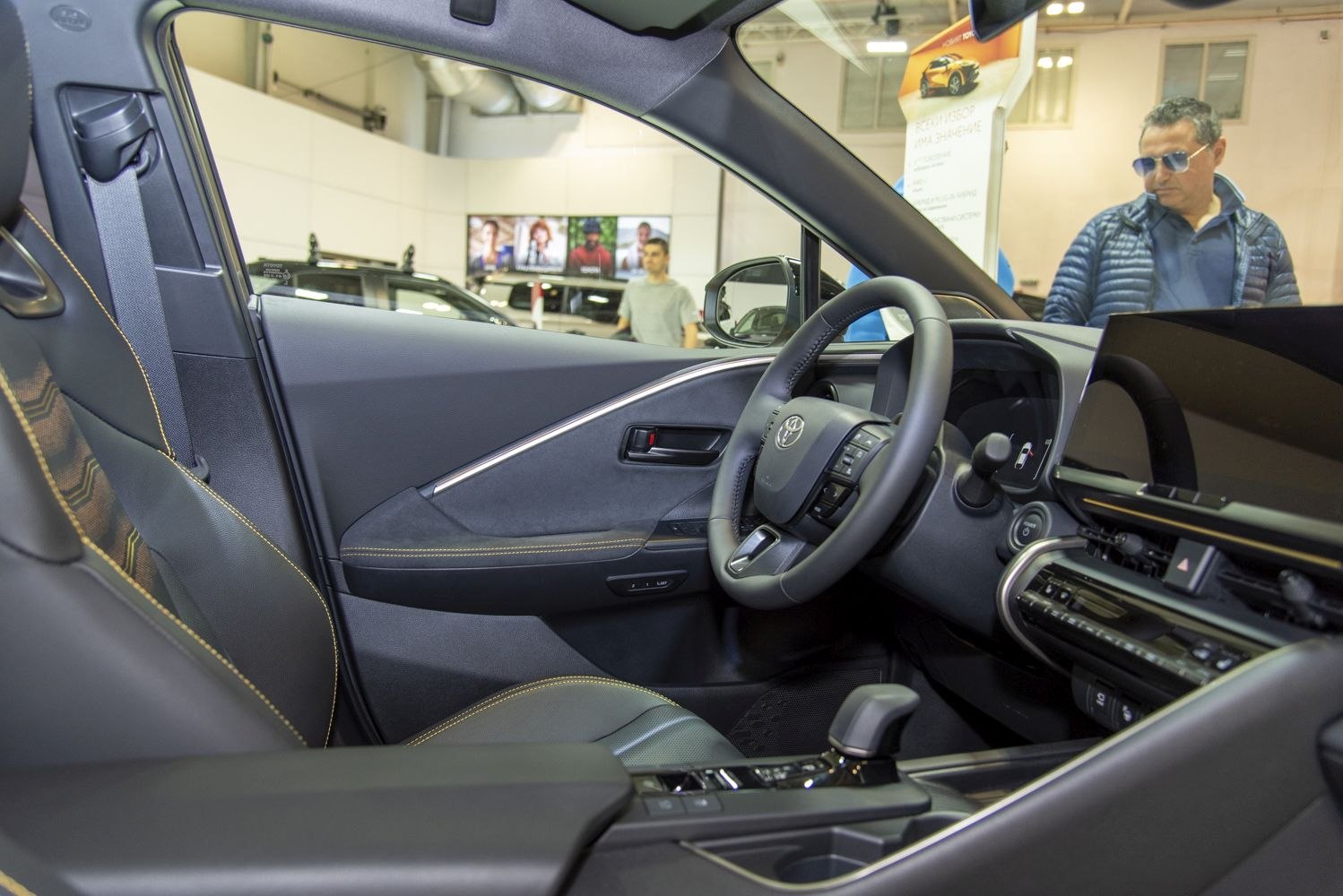 Modern car interior with dashboard, steering wheel, and leather seats.