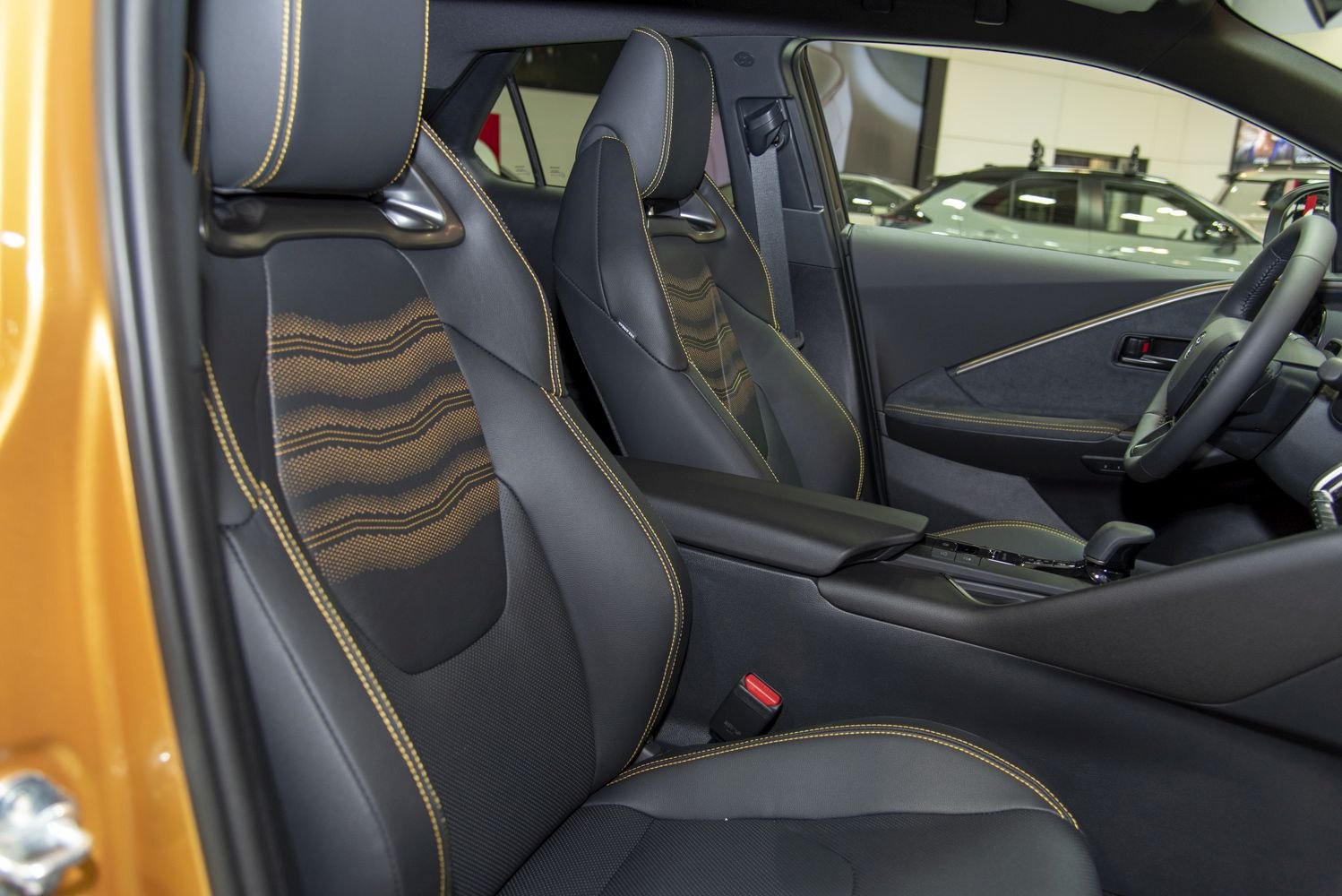 Sporty leather front seats with orange stitching and ergonomic armrest