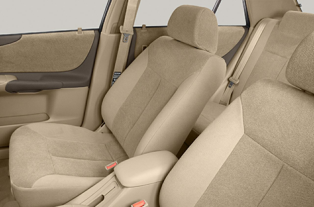 Beige fabric front seats with door panel and seatbelt