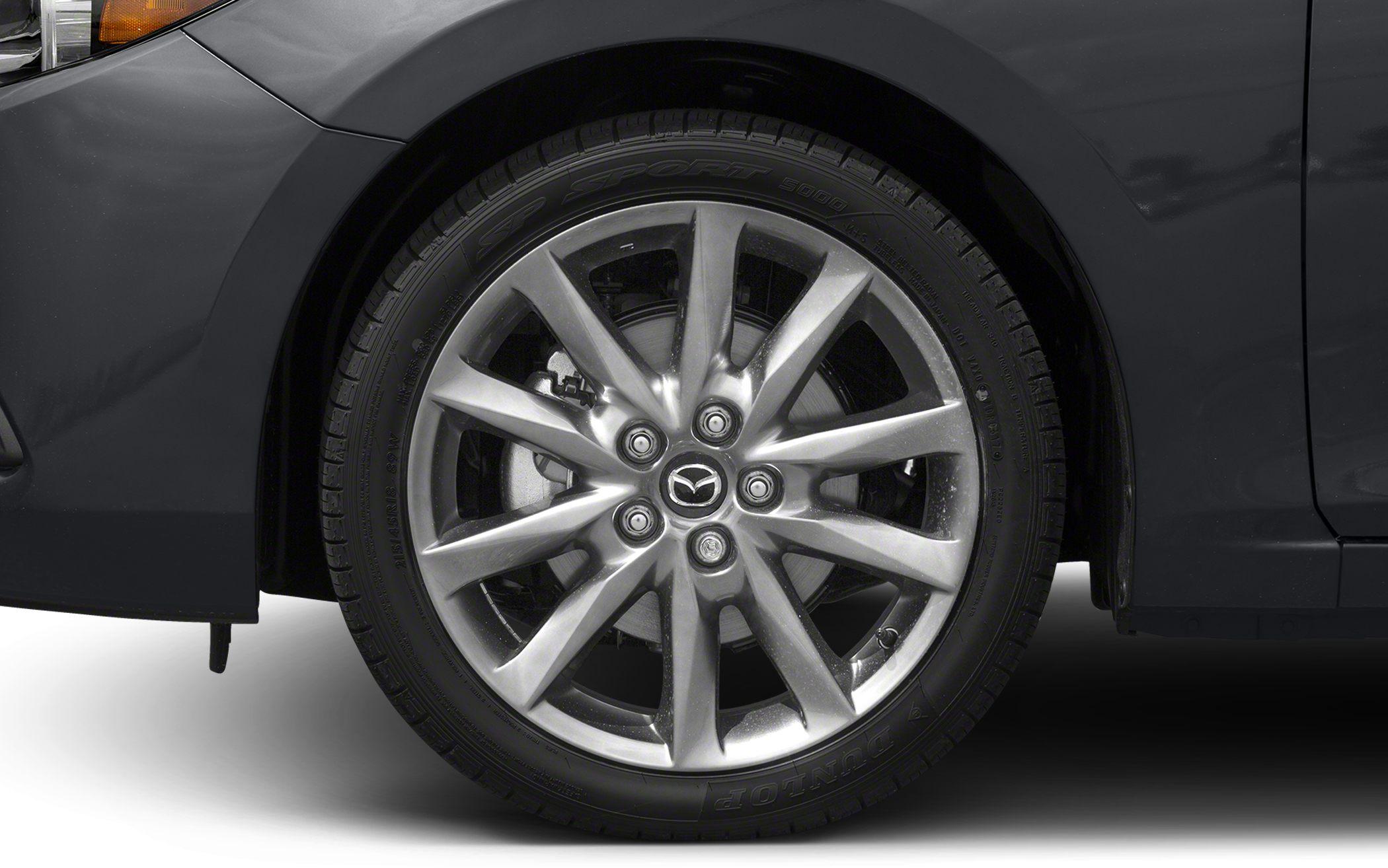 Close-up of alloy wheel with Mazda logo and Dunlop tire.