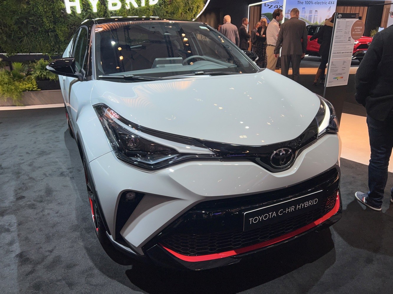 Front view of hybrid crossover with distinctive LED headlights and black-accented grille