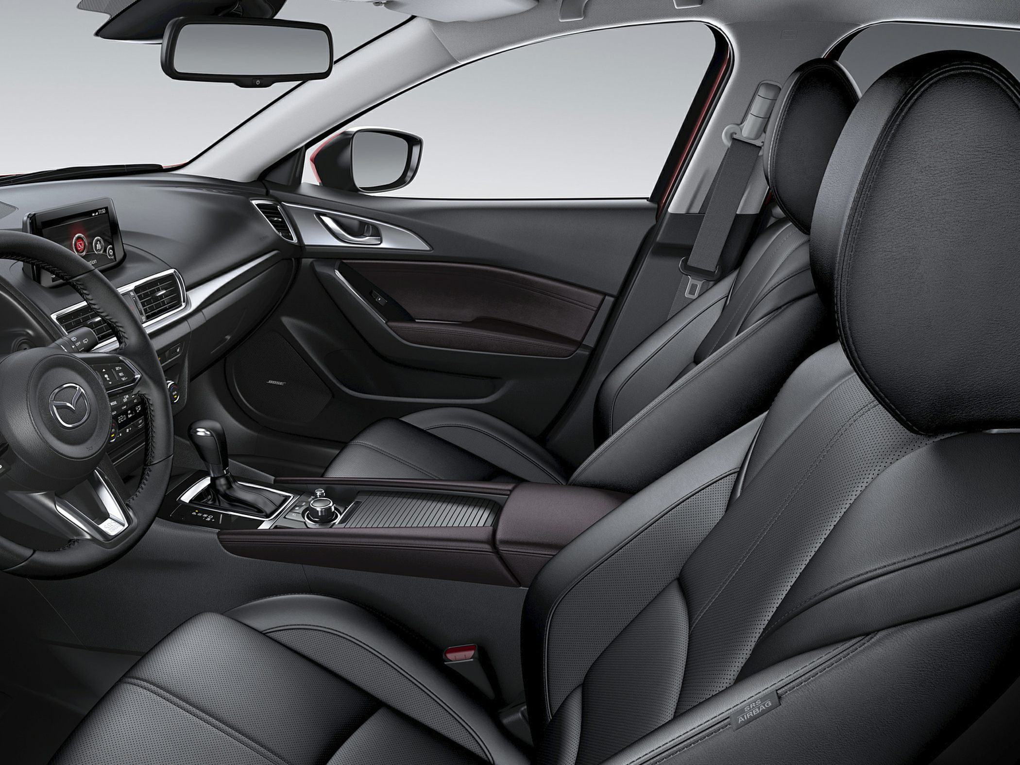 Black leather seats and modern dashboard with control knob and automatic gear shift