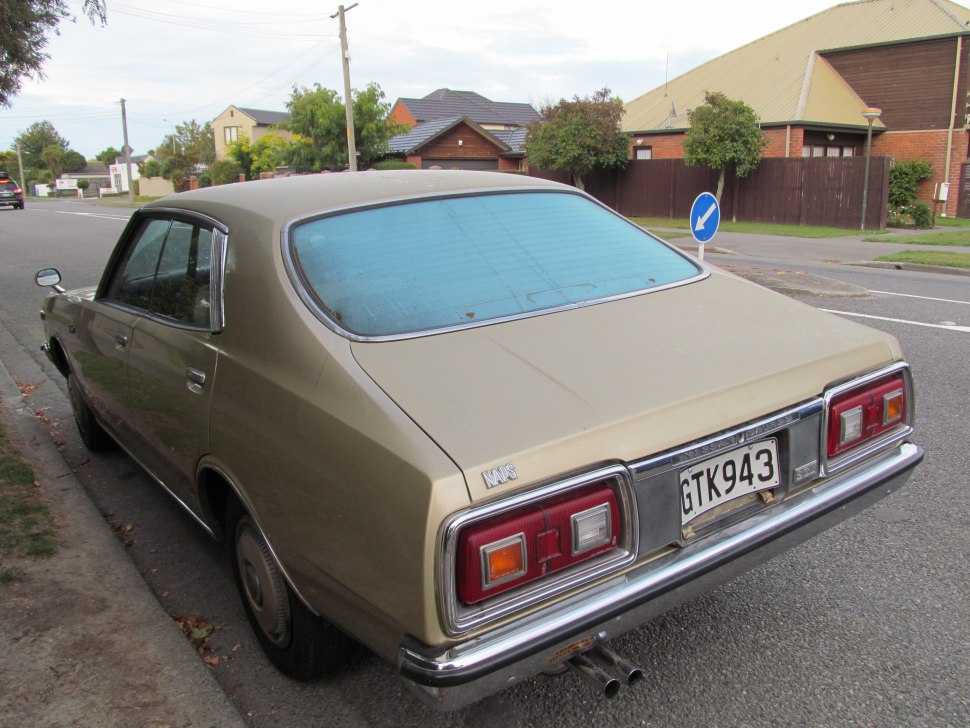 Rear view of vintage sedan with classic rear lights and dual exhaust pipes