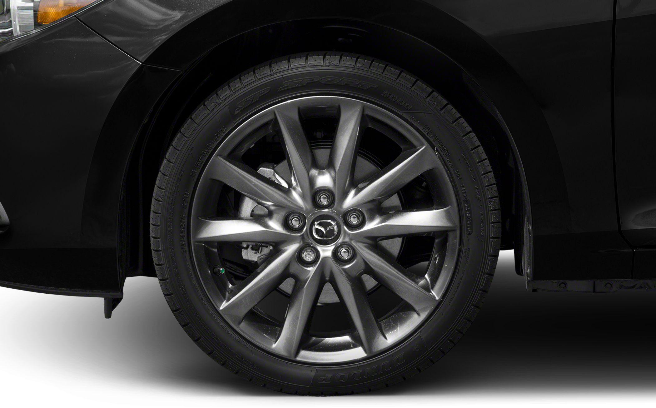 Closeup of alloy wheel with Mazda logo and tire.