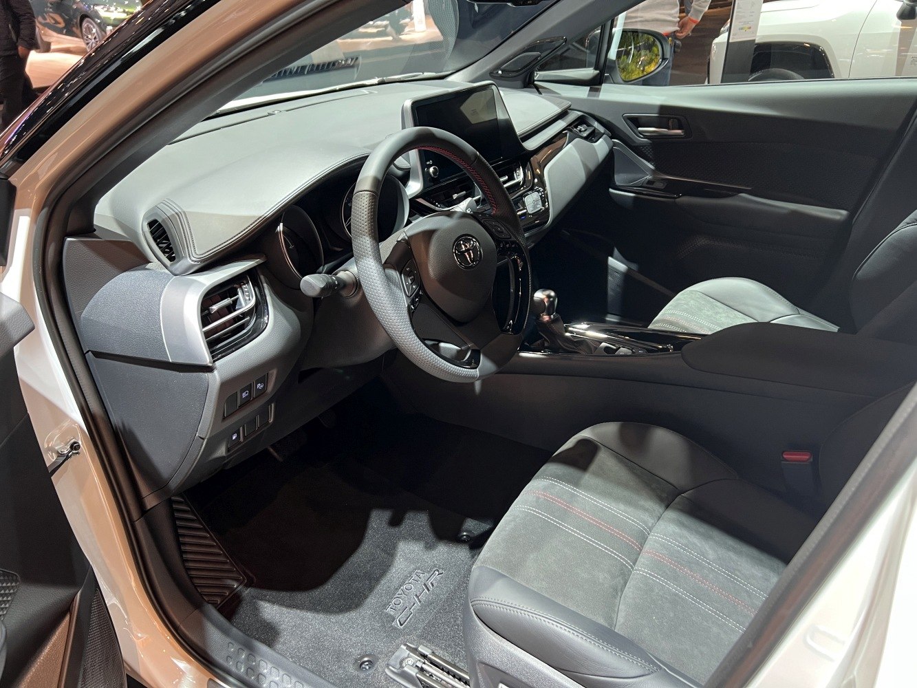 Modern car interior with dashboard, steering wheel, and premium seats