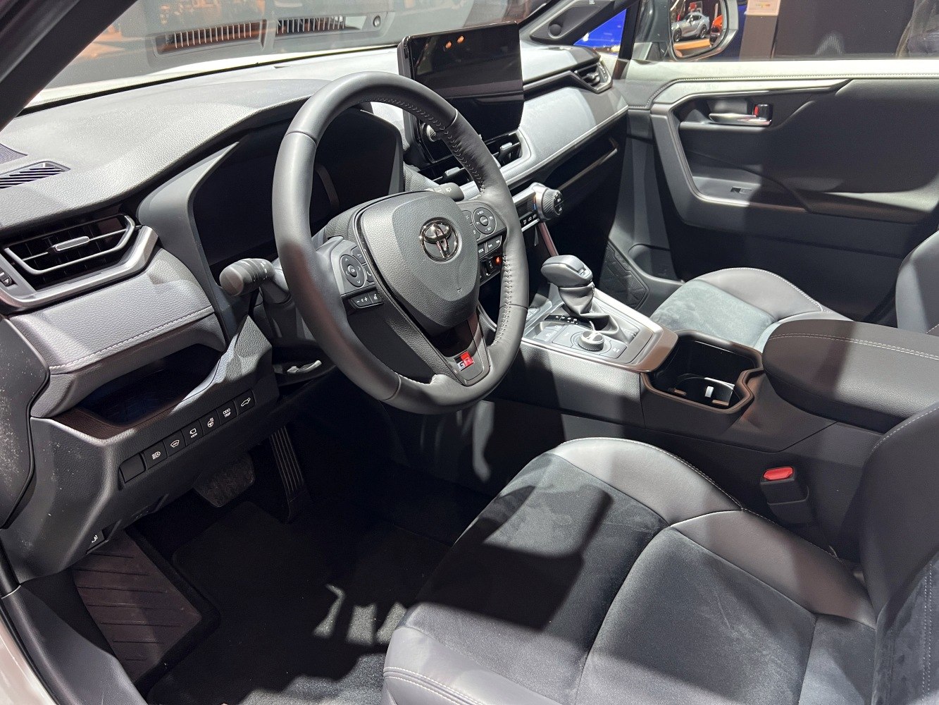 Modern car interior with steering wheel and touchscreen display