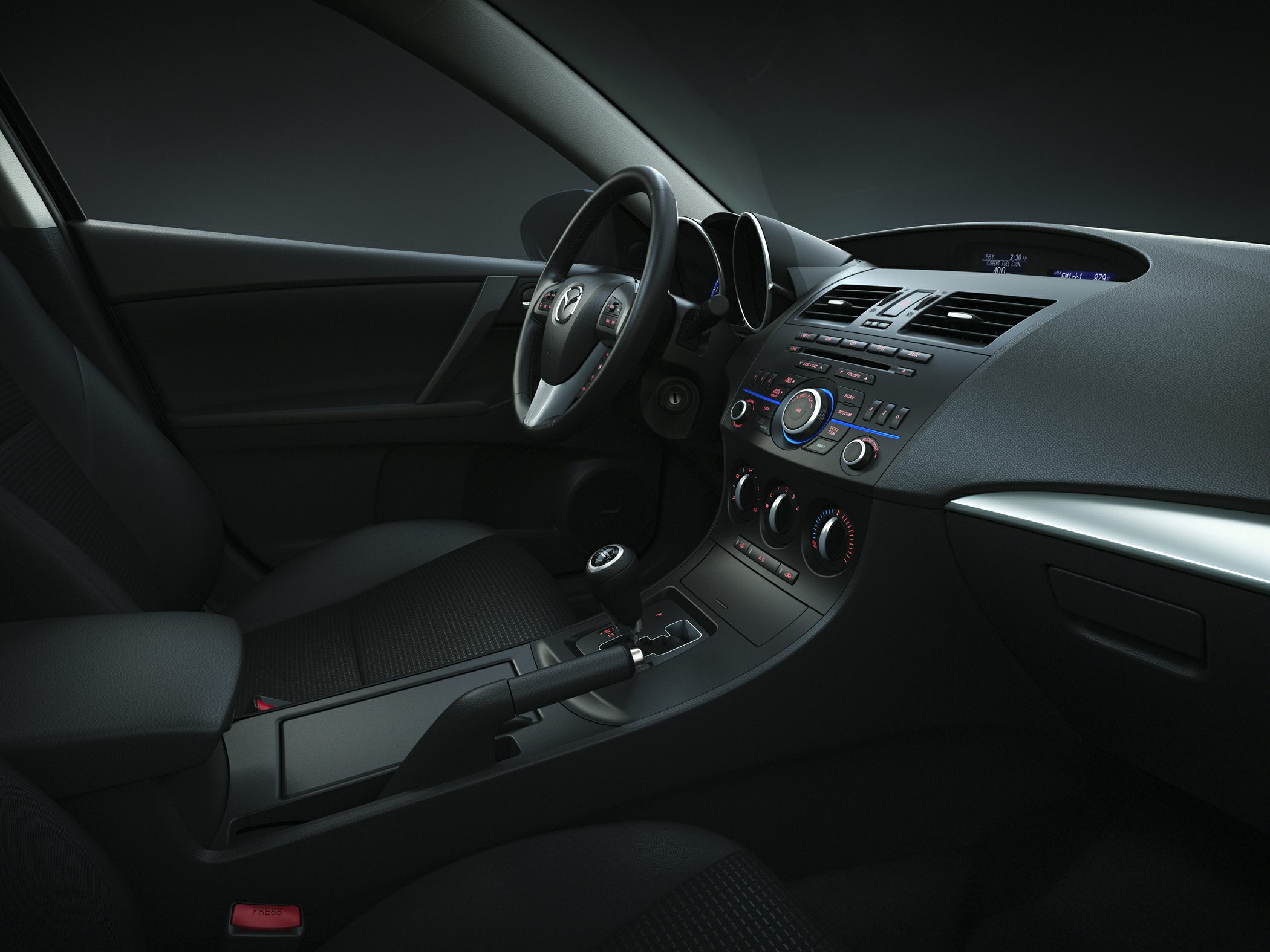 Modern car interior with dashboard, center console, and steering wheel.