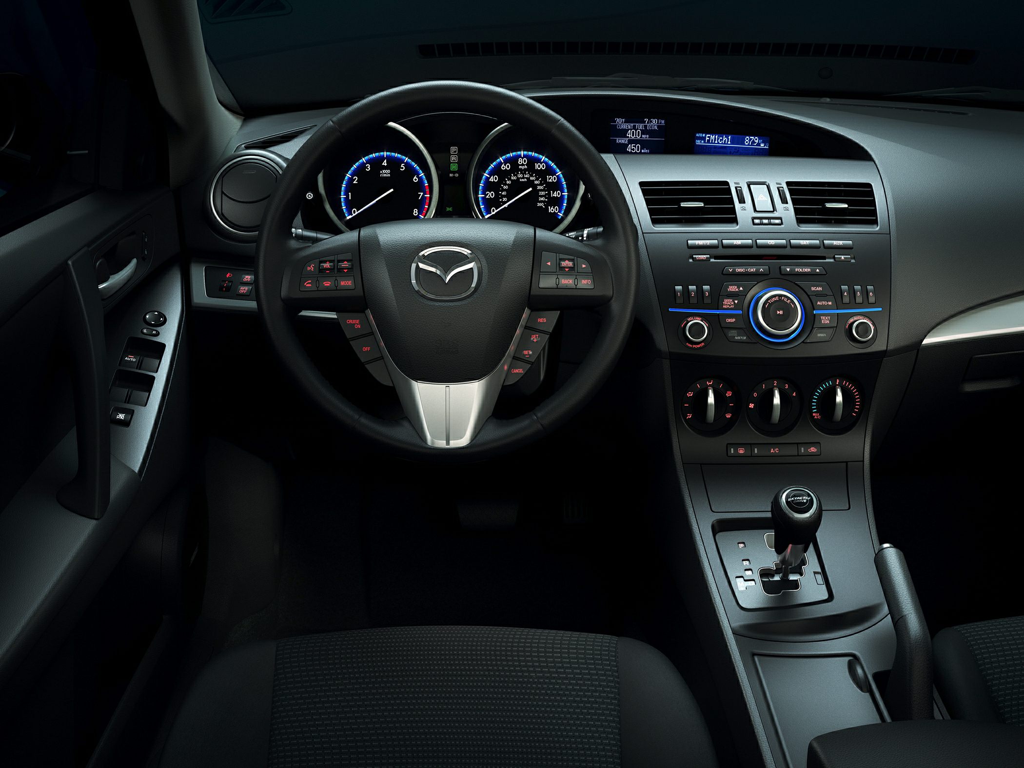 Dashboard and steering wheel with integrated control buttons and central console layout
