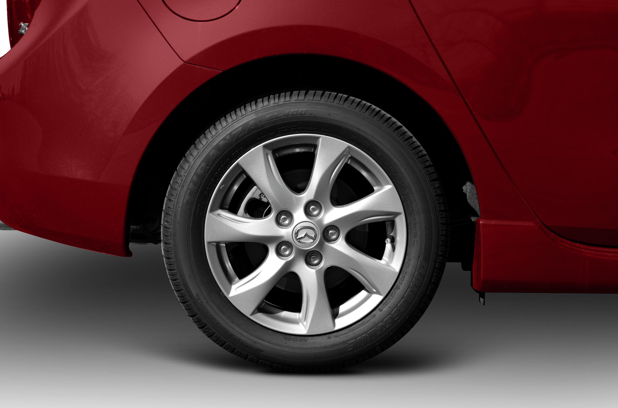 7-spoke silver alloy wheel with Bridgestone tire close-up