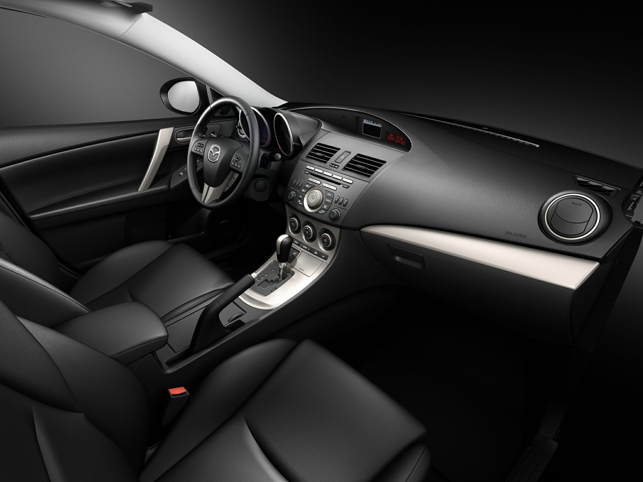Interior dashboard, steering wheel, and center console with controls