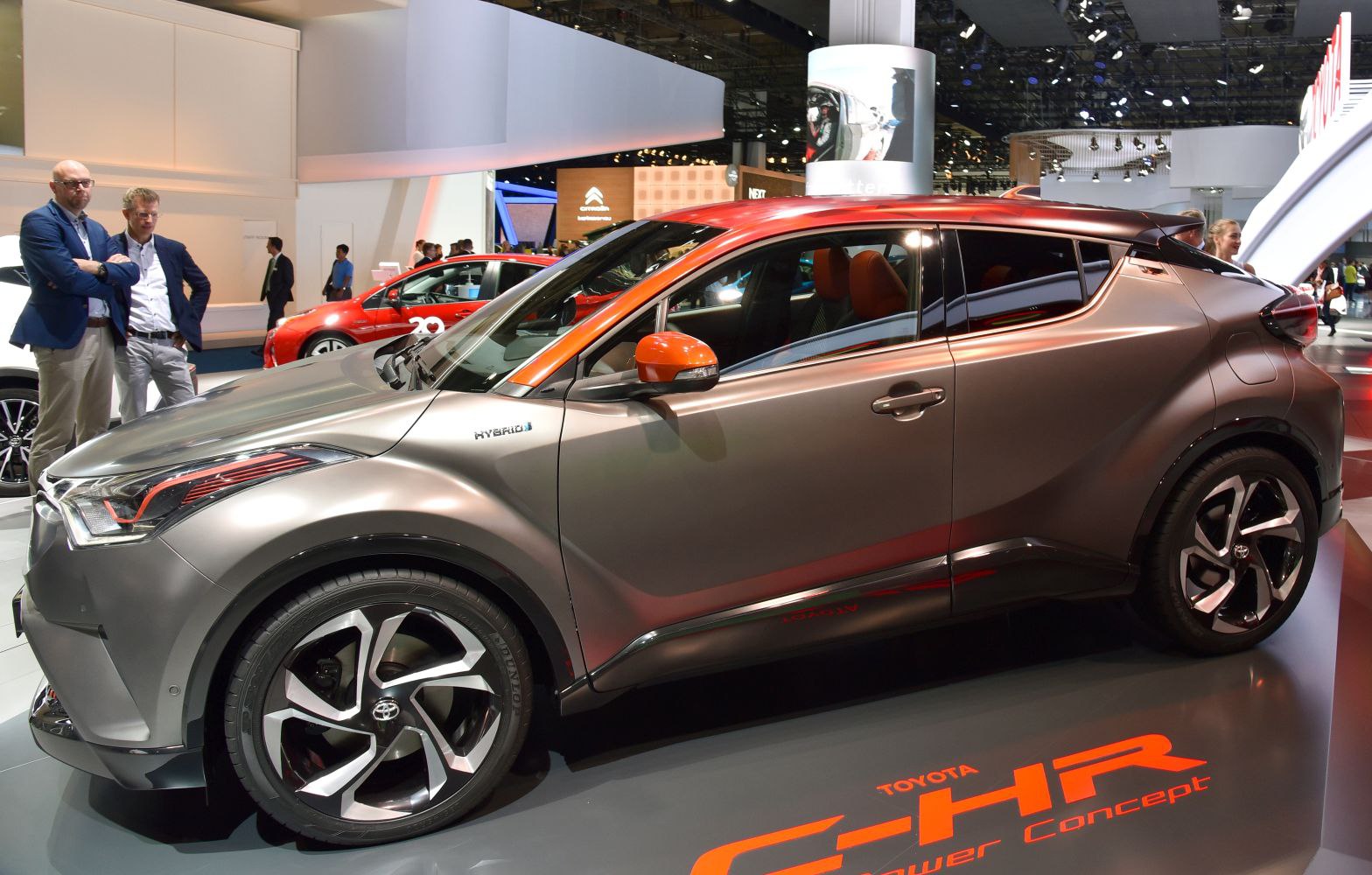 Side view of sleek hybrid crossover with orange accents and futuristic design