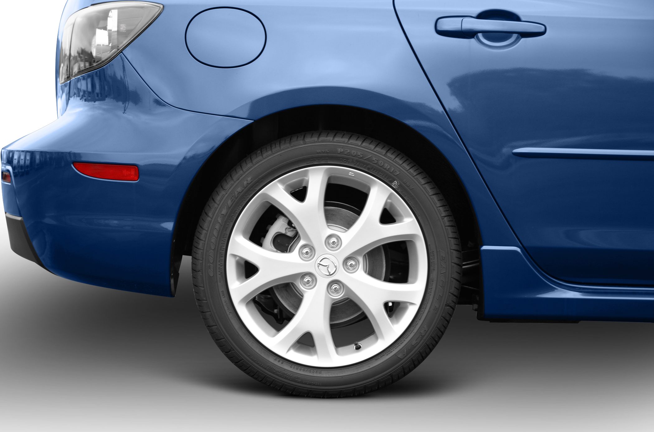 Rear wheel and panel close-up with fuel cap and door handle