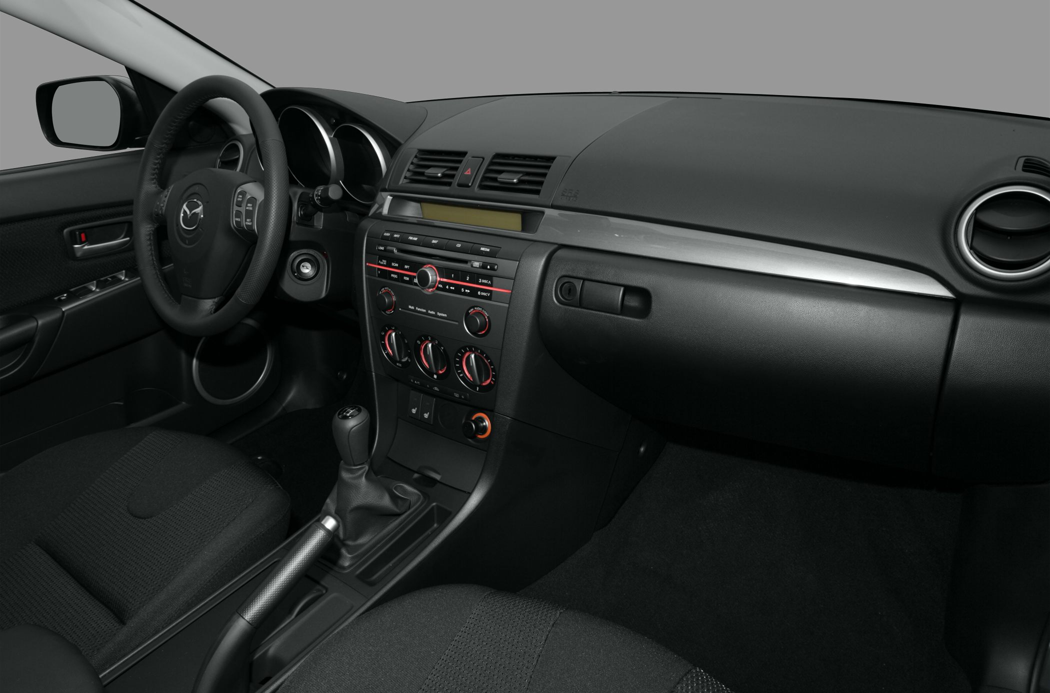 Car interior dashboard, gearshift, steering wheel, and climate controls