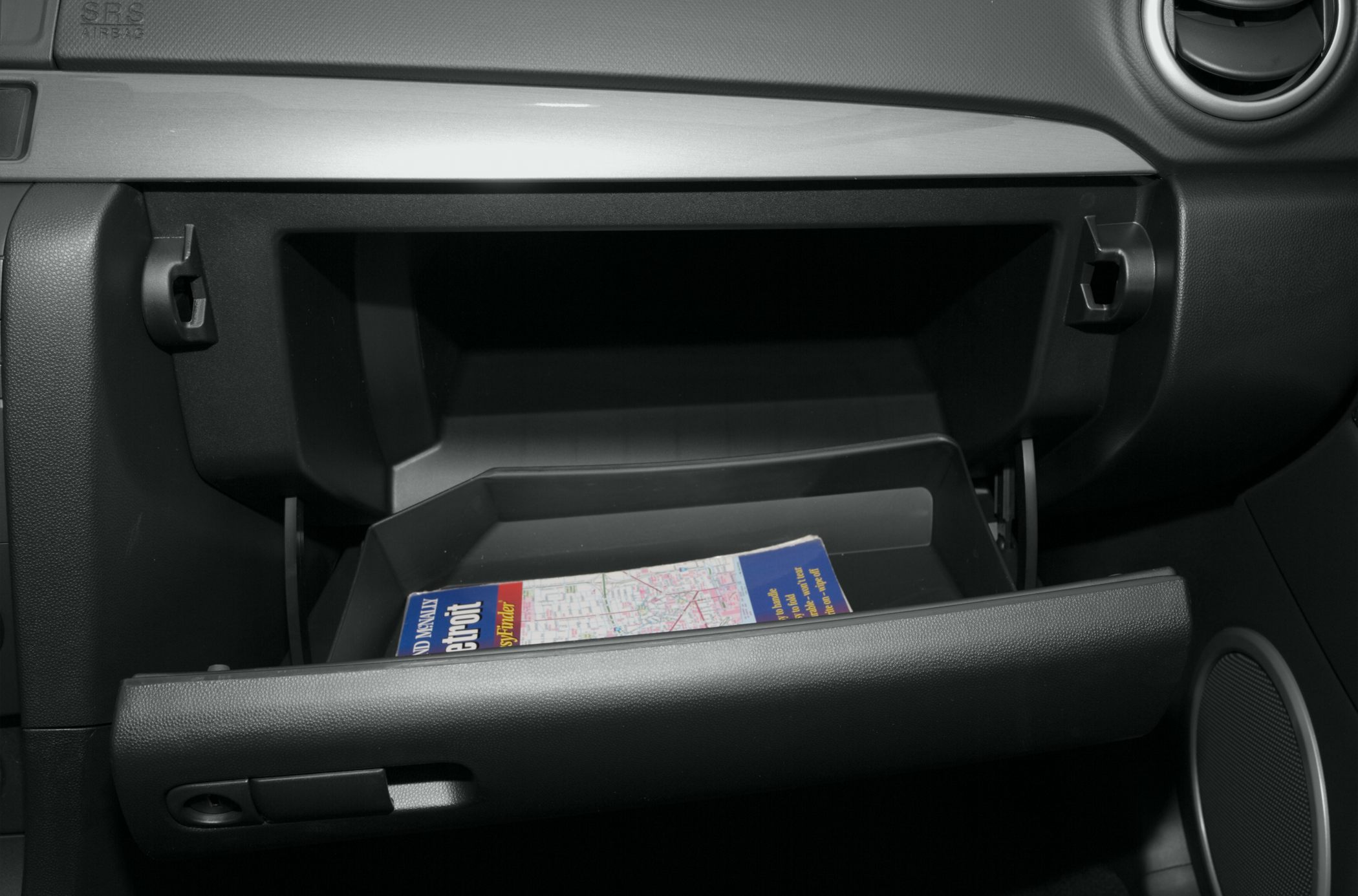 Open glove compartment with a map inside