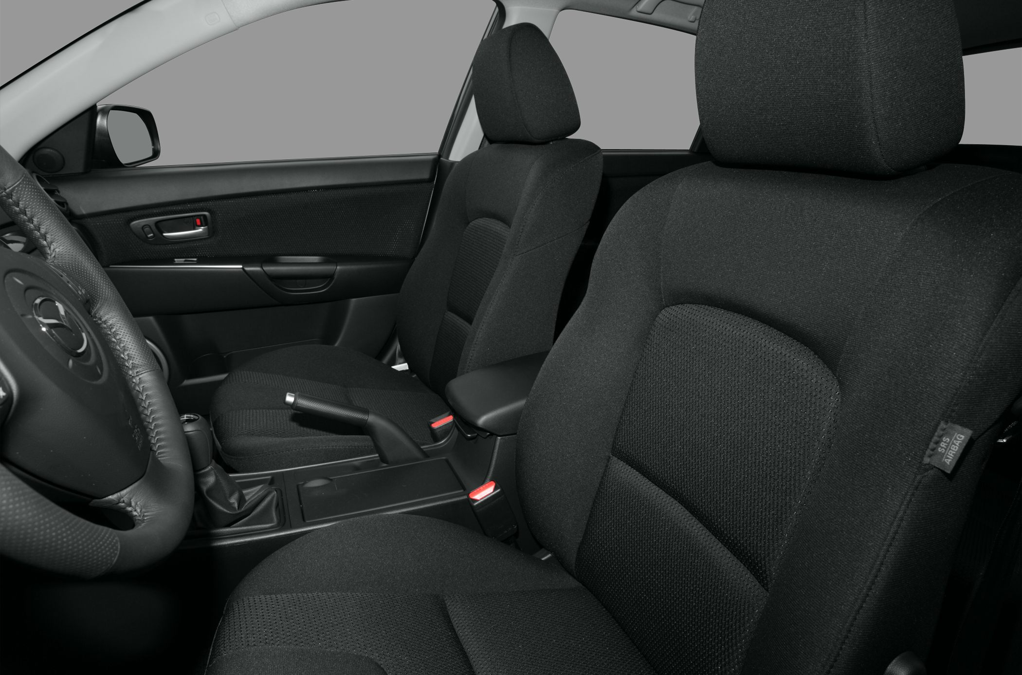 Front seats and interior layout with fabric upholstery and handbrake