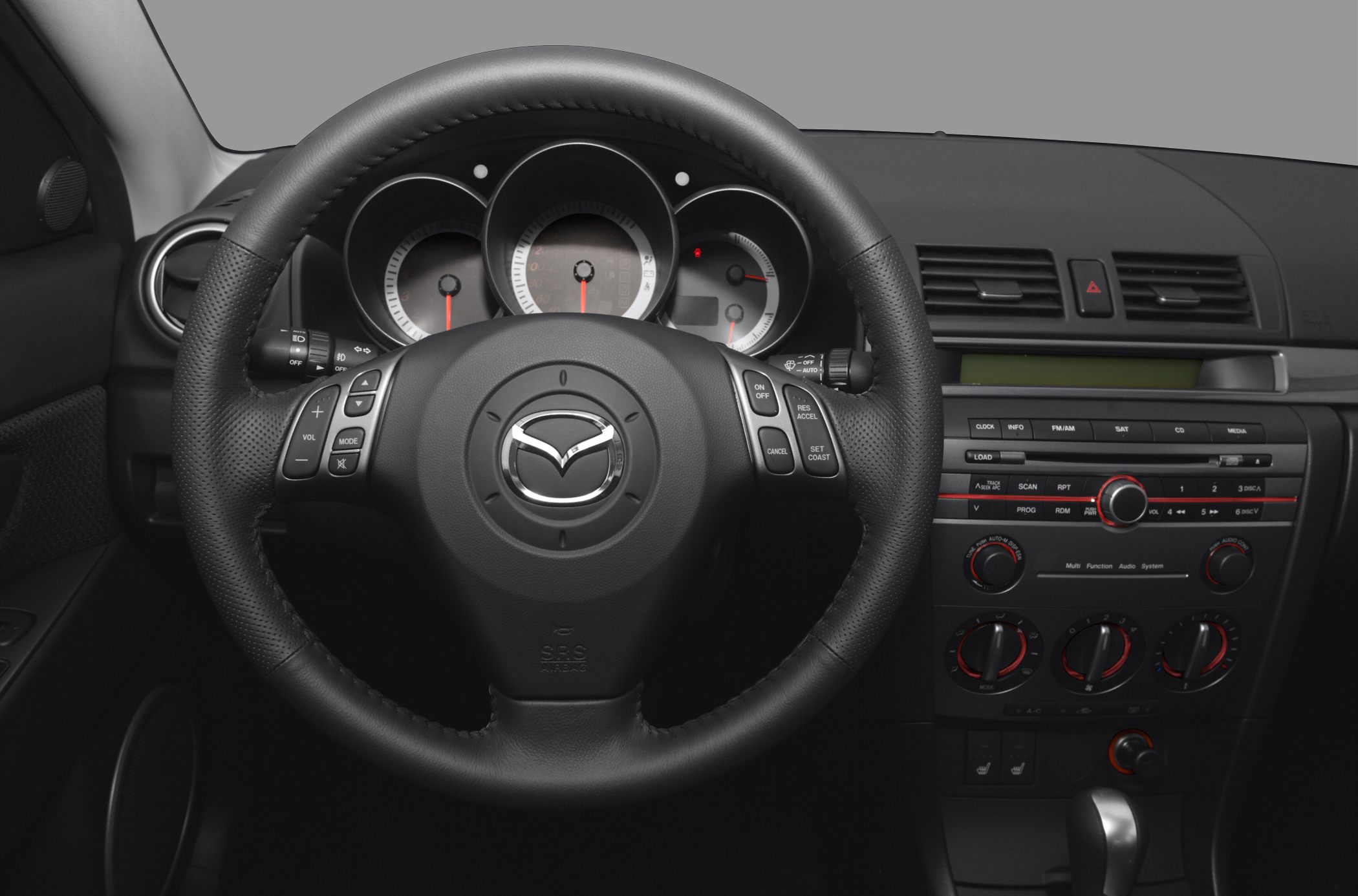Steering wheel, dashboard gauges, and center console with controls