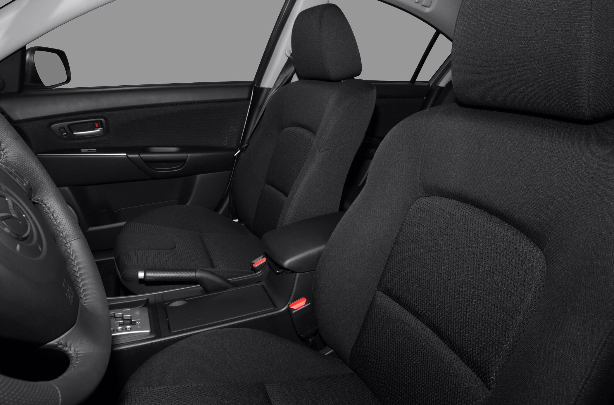 Front seats and center console with handbrake and steering wheel