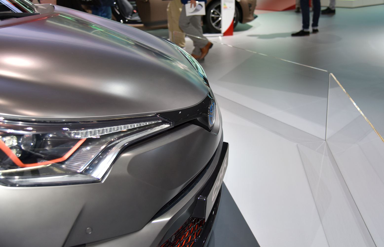 Close-up of sleek headlight and smooth hood with futuristic front grille