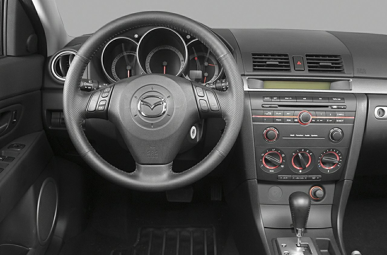 Interior dashboard and steering wheel with control buttons and air vents