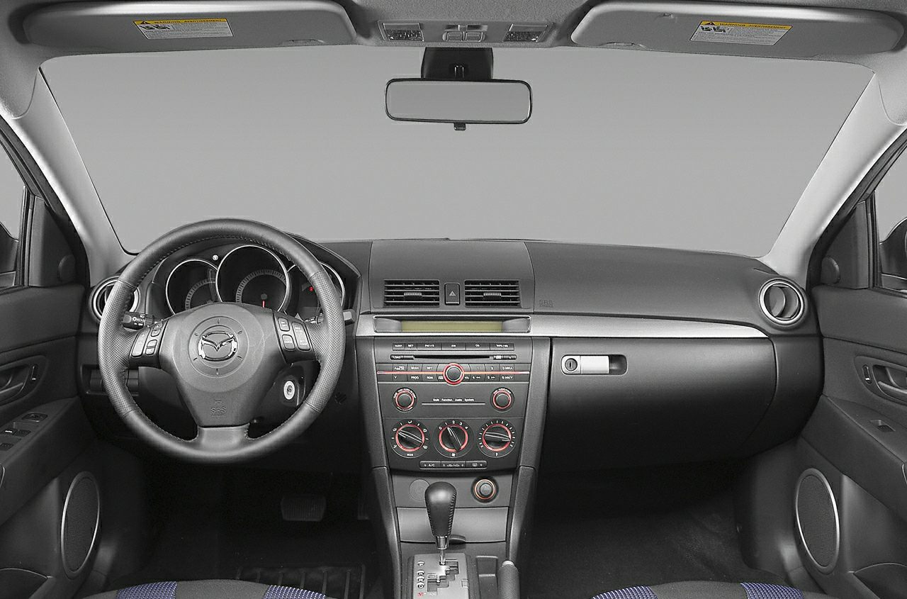 Car interior dashboard and steering wheel with controls and air vents