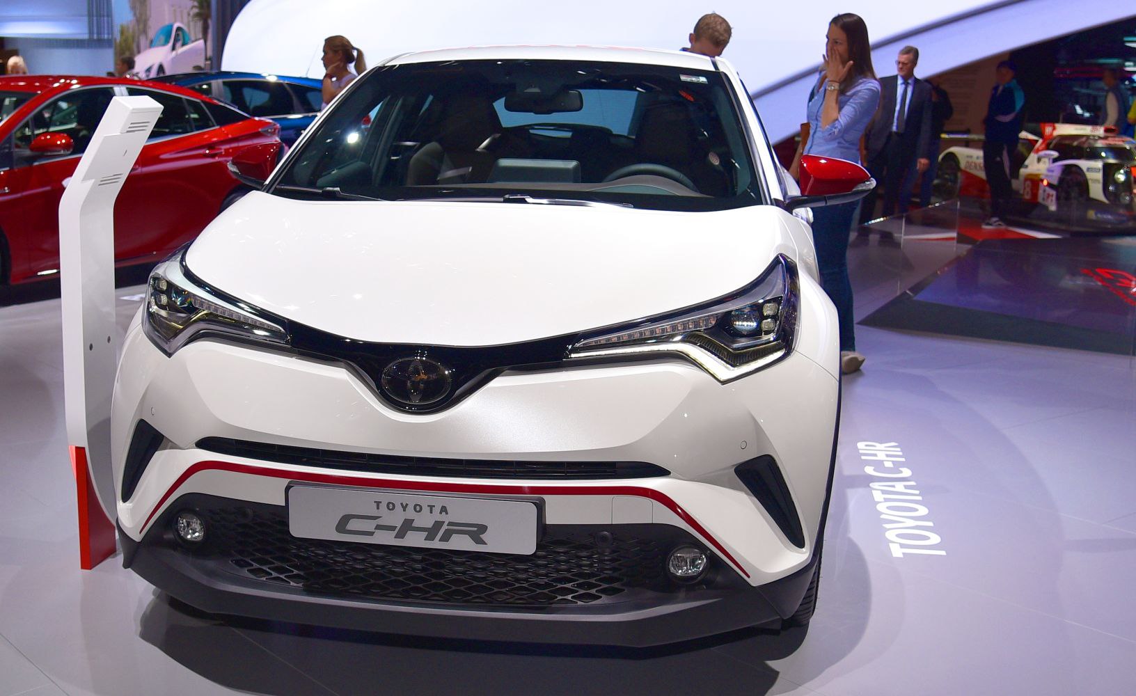 Sharp headlights and bold front grille of a white compact SUV