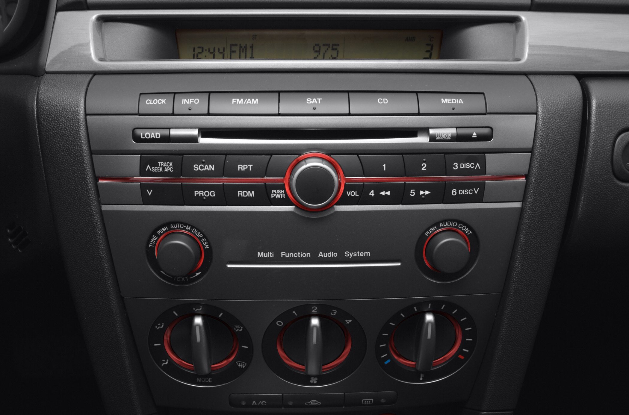 Car audio system and air conditioning controls with red trim knobs