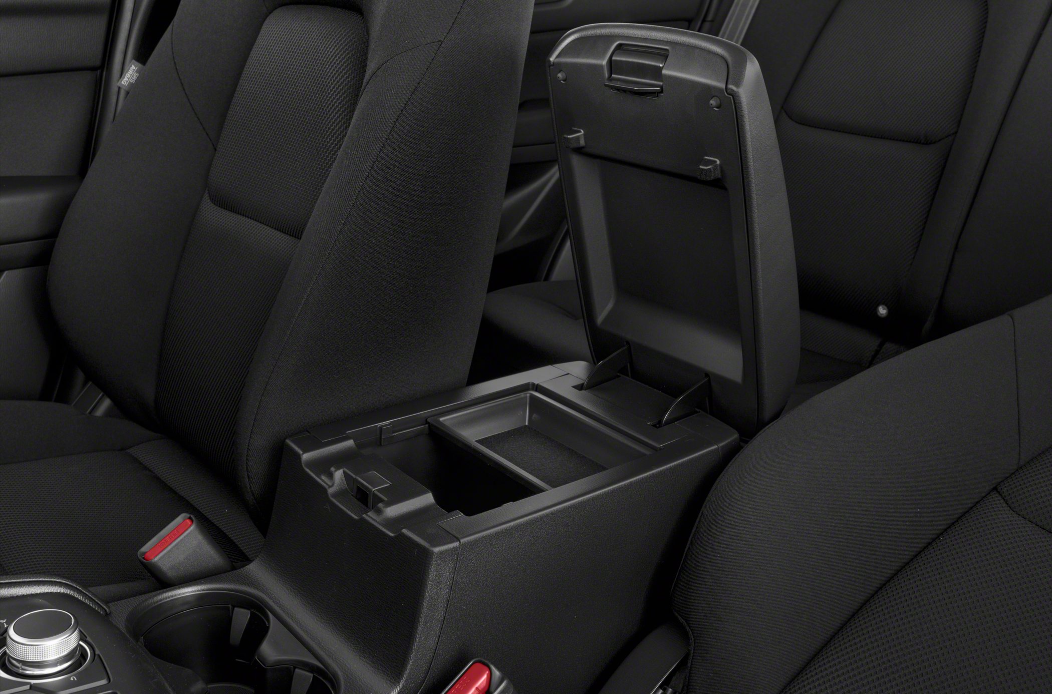 Center console storage compartment with adjacent black fabric seats
