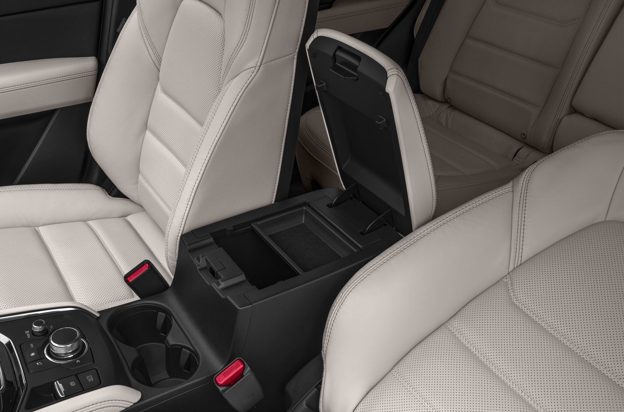 Beige leather seats and open center console storage with cup holders