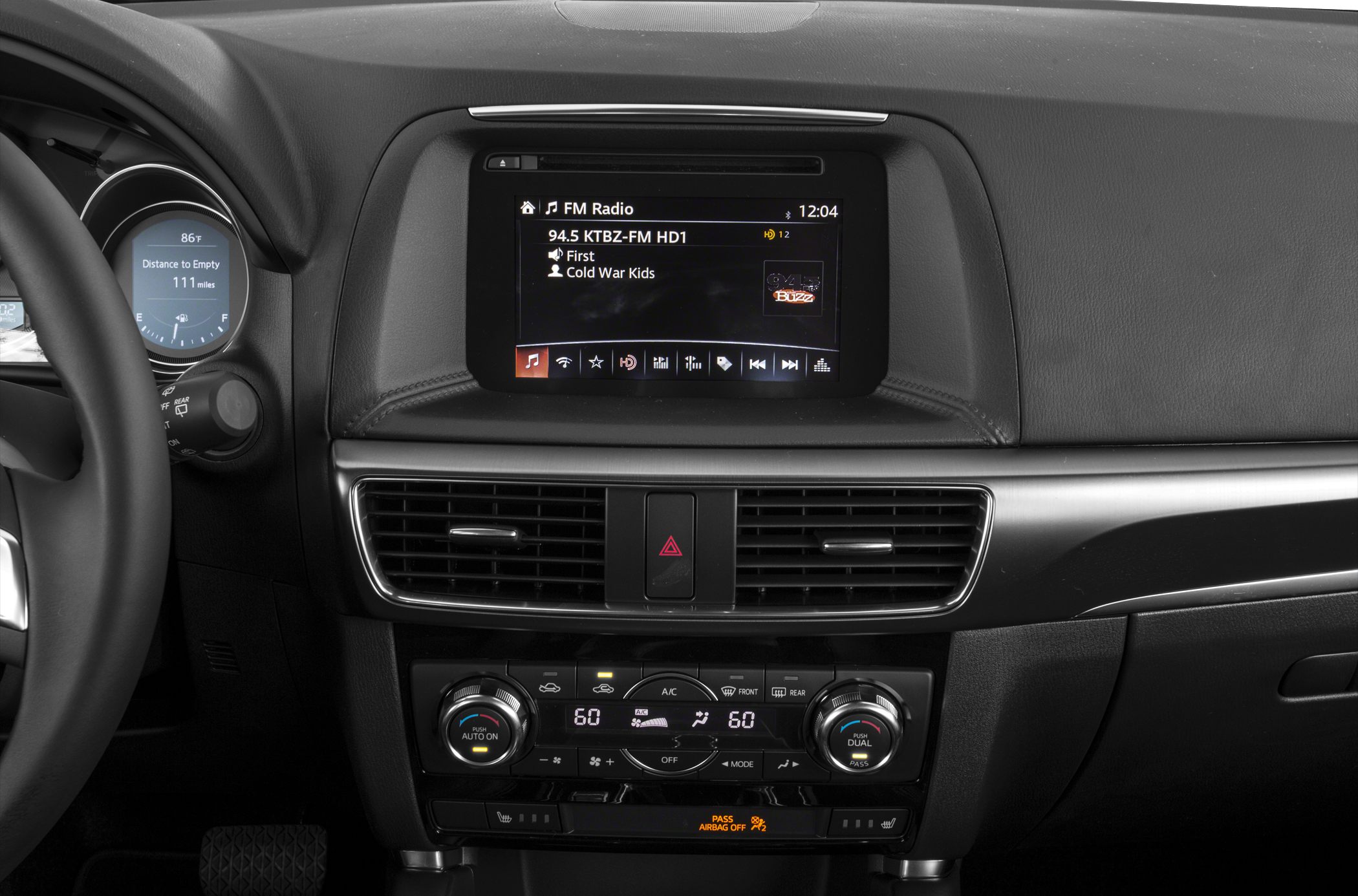 Central infotainment screen and dual-zone climate control system in car dashboard