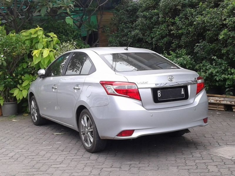 Silver sedan rear view with distinct tail lights and trunk design
