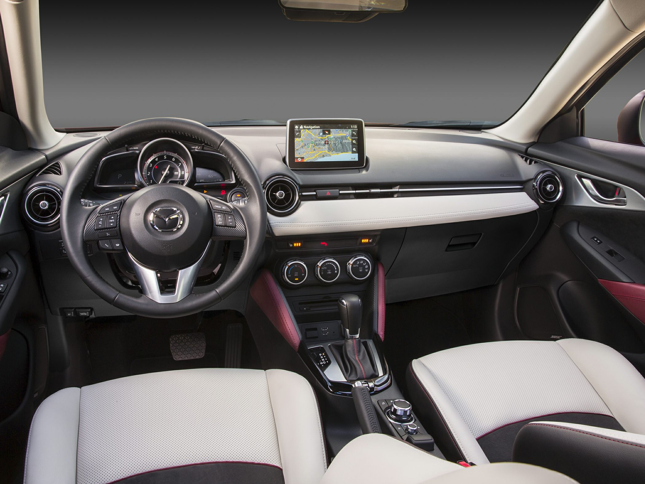 Dashboard with navigation screen, leather steering wheel, and center console controls