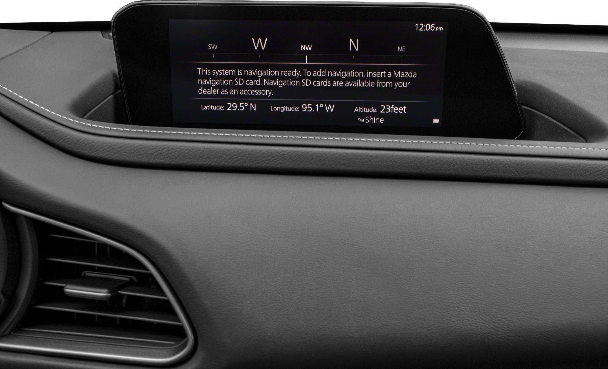 Navigation system display and dashboard with air vent and stitching detail.