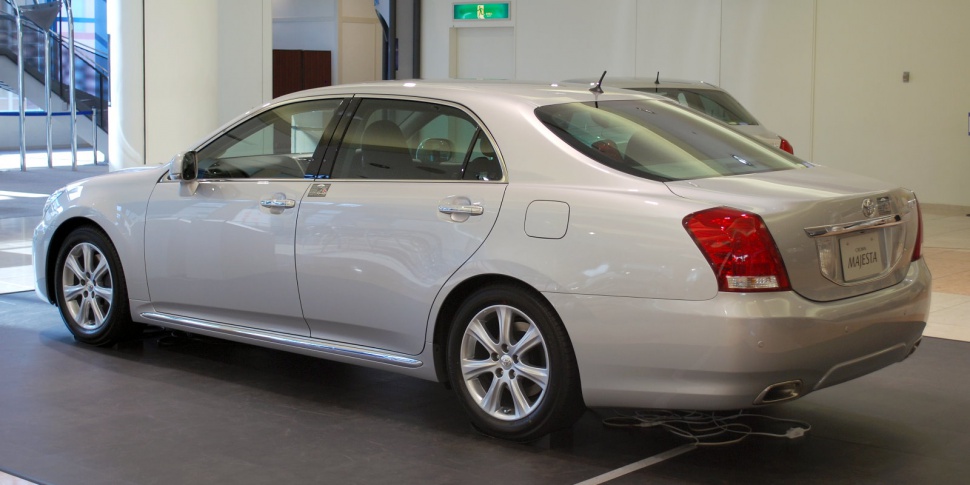 Luxury car rear side view with smooth body lines and chrome trim