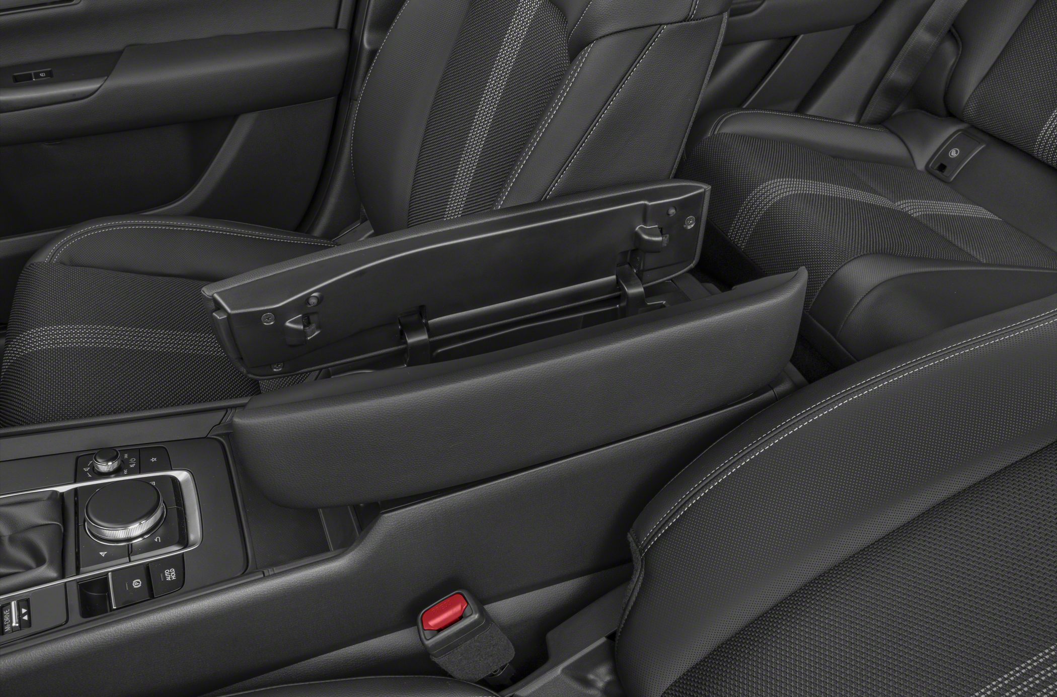Center console armrest with storage and stitched upholstery.