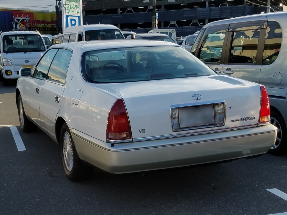 Rear view of luxury sedan with V8 badge and characteristic taillights