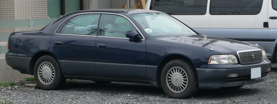 Side profile of a classic sedan with detailed wheel design.