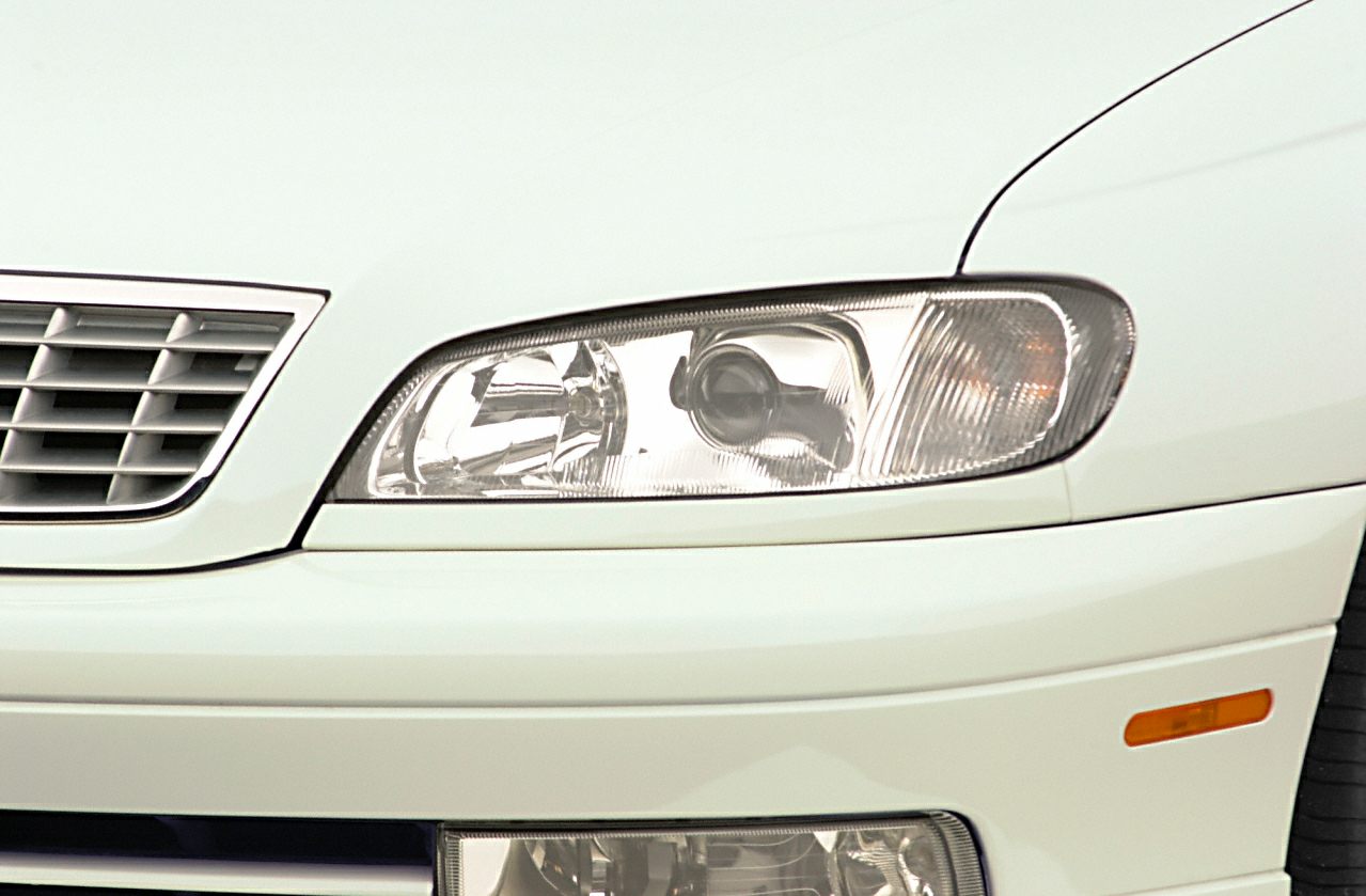 Close-up of front headlight and grille with fog light and amber side marker