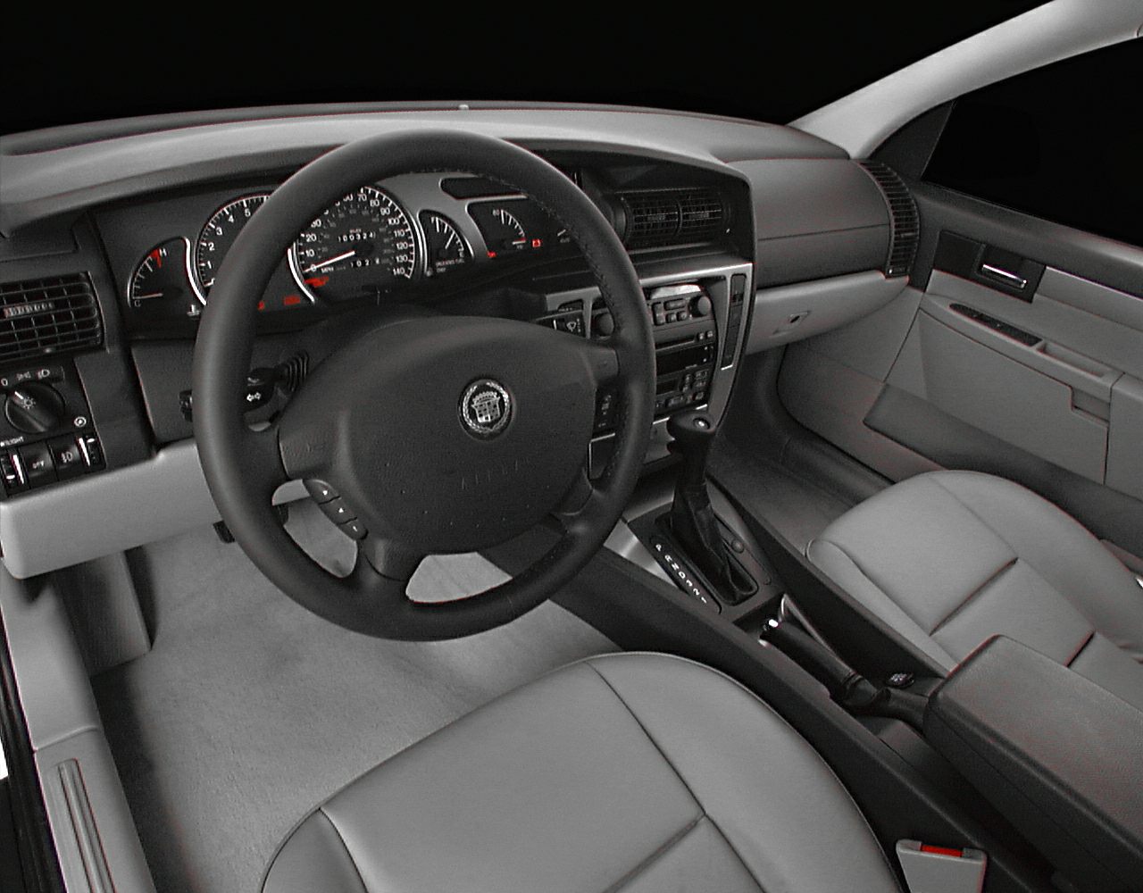 Car interior with dashboard, steering wheel, and central console.