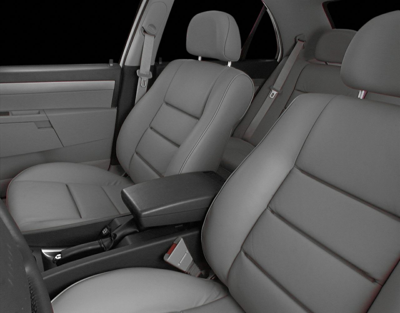 Gray leather front seats and center armrest with seat belts