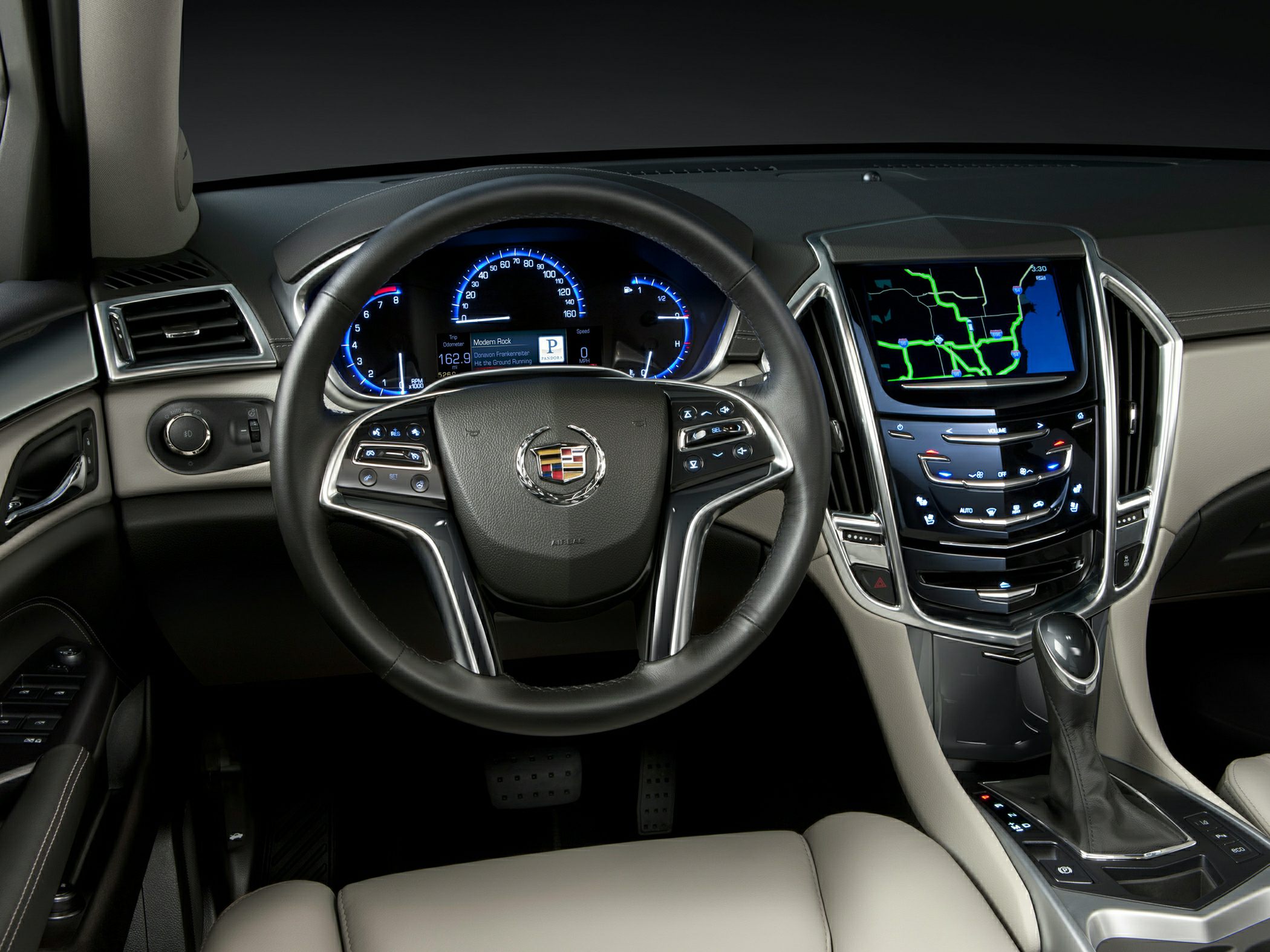 Steering wheel, illuminated gauges, digital infotainment display, gearshift