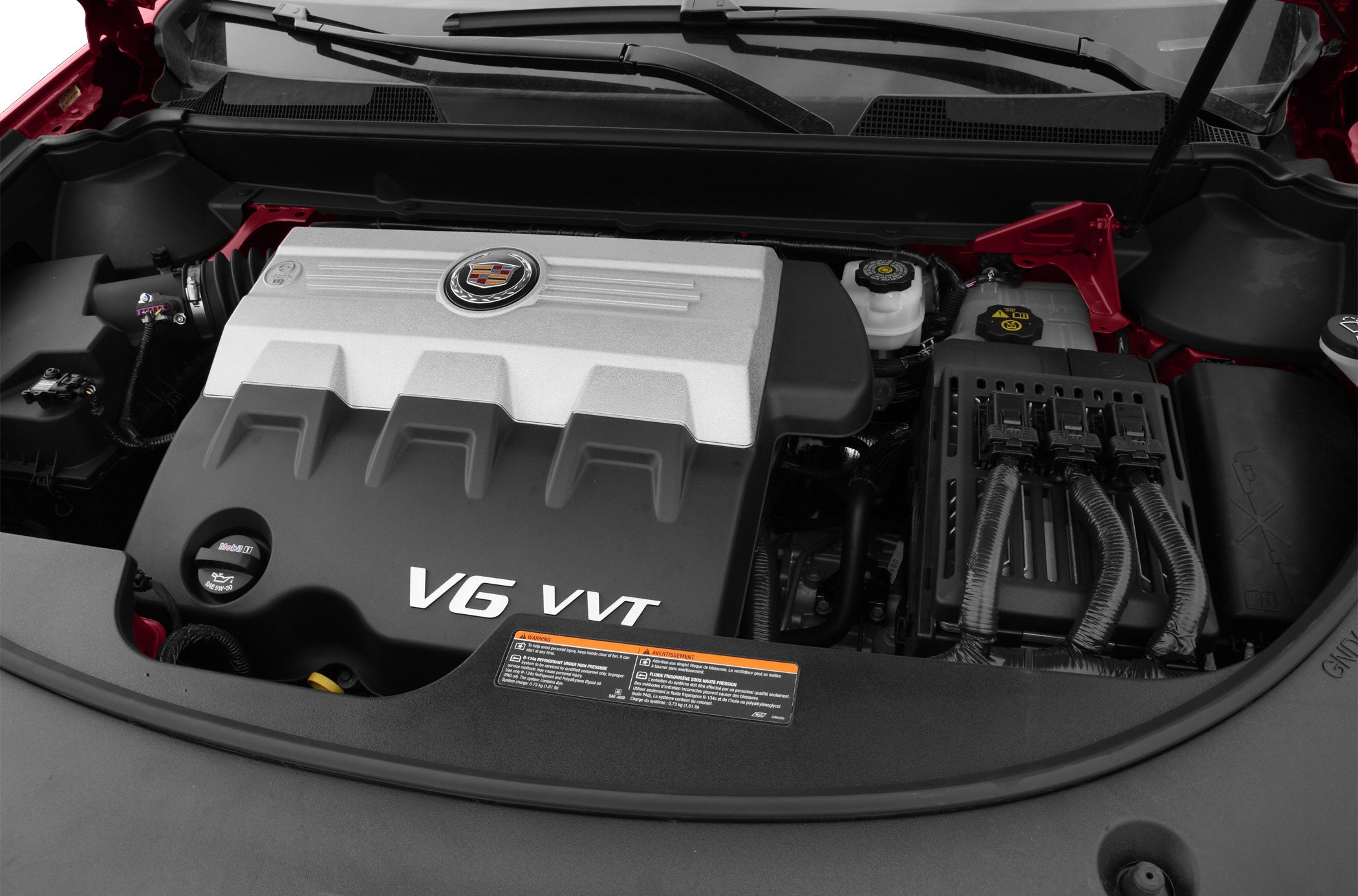 Close-up of a V6 VVT engine under the hood with visible engine cover and components.