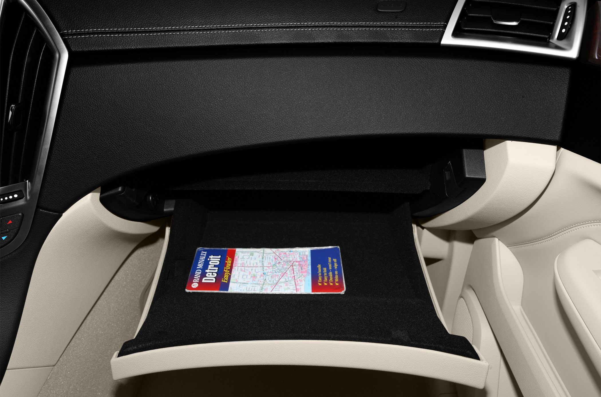 Opened glove compartment with a map booklet inside
