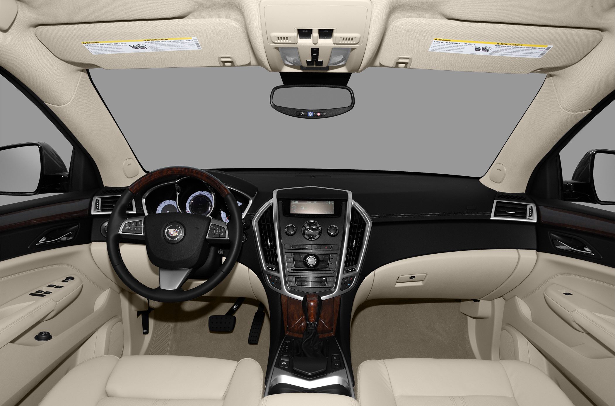 Luxury SUV interior with beige leather seats and wood-trimmed dashboard