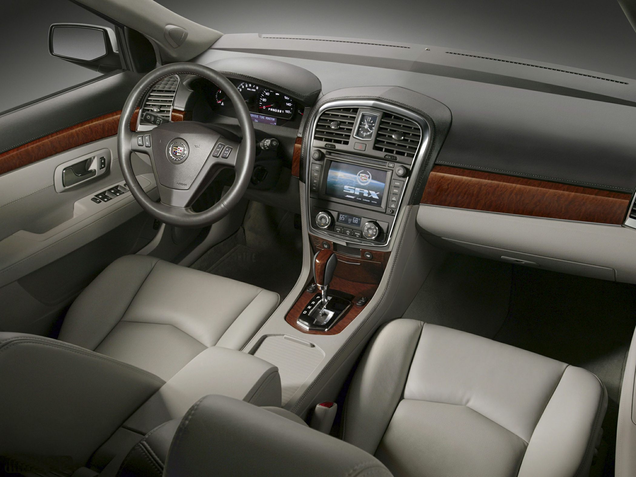 Leather seats and wood trim interior with navigation system and analog clock