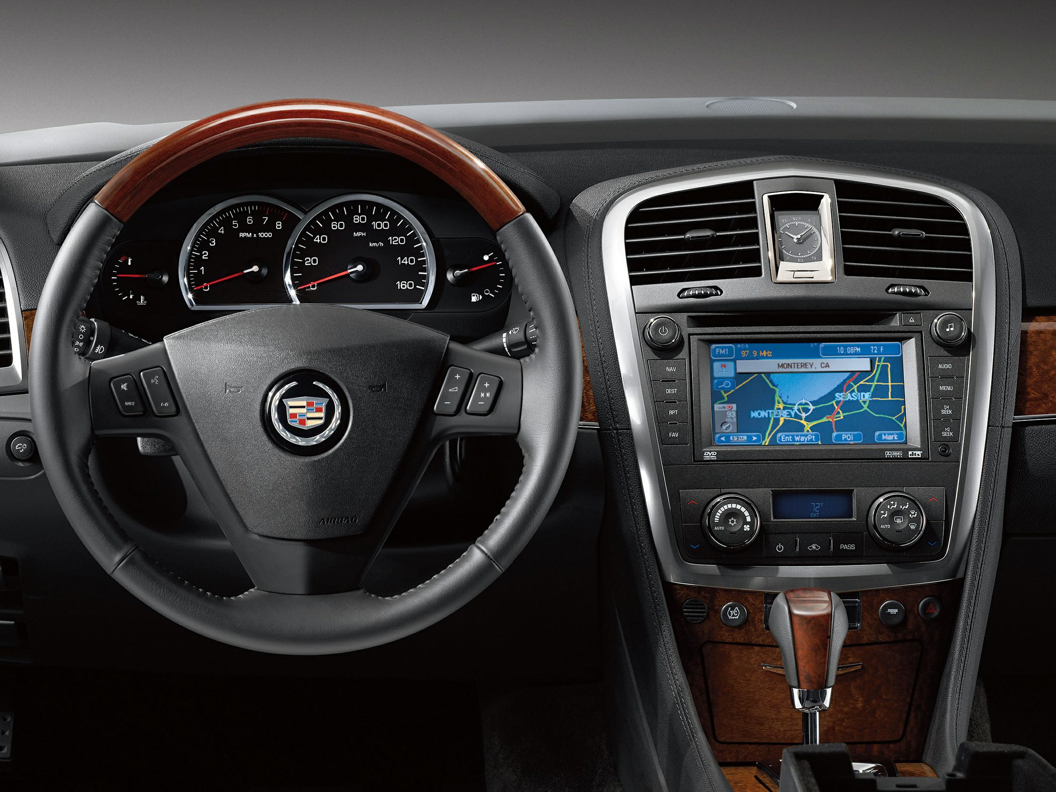 Wooden-trimmed steering wheel and dashboard with navigation system